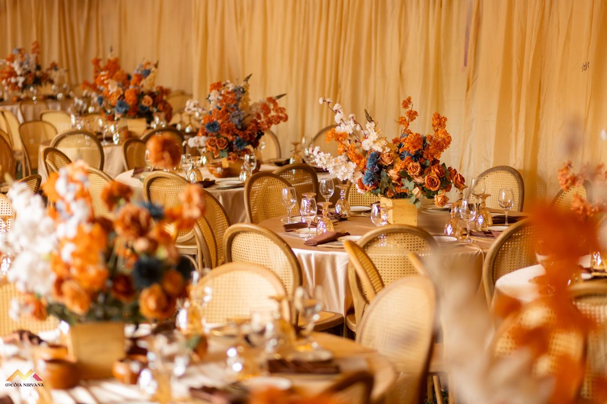 Reception tables with rattan chairs and terracotta florals